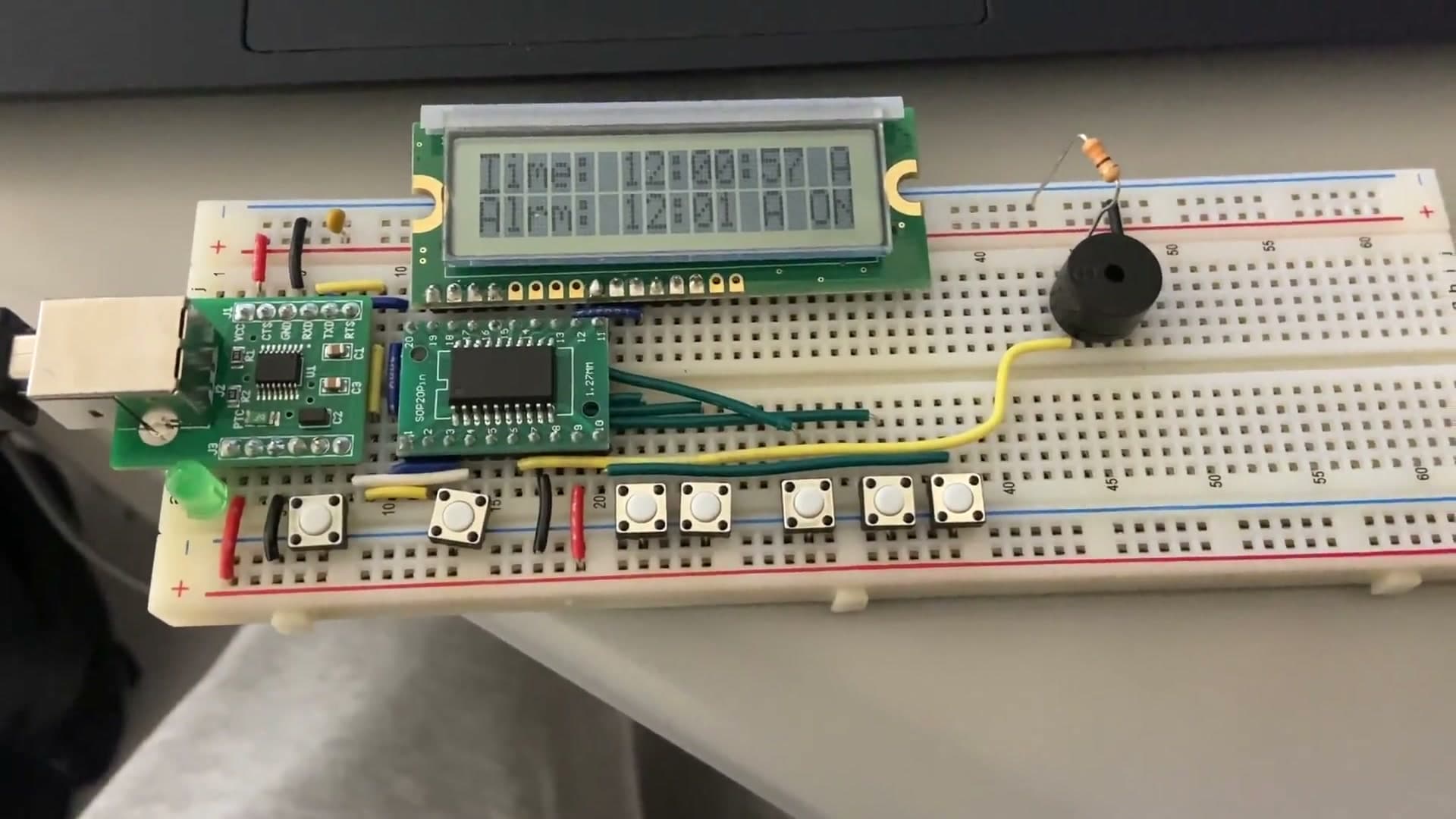 Alarm clock running on the N76E003 dev board with the LCD showing the current time
