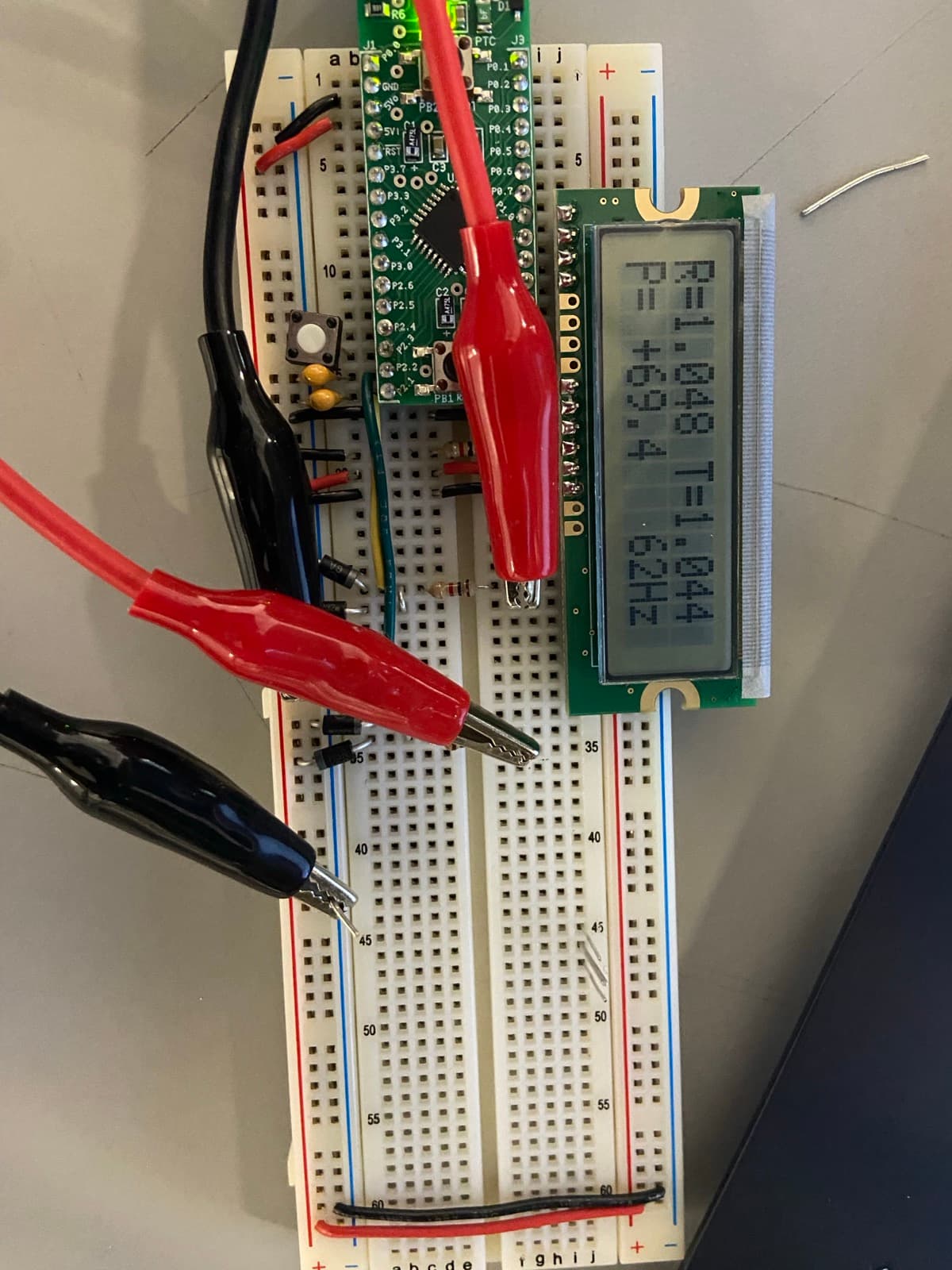 Phasor voltmeter prototype displaying R, T, and P readings on the LCD